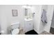 Bright bathroom features a toilet, sink, mirror and decorative sign providing a clean and functional space at 1617 Jenkins Rd, Wake Forest, NC 27587