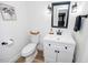 Well-lit bathroom featuring vanity with drawers, white toilet, and decorative artwork at 1617 Jenkins Rd, Wake Forest, NC 27587