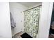 Cozy bathroom featuring a shower with a stylish tropical-themed curtain and neutral flooring and walls at 1617 Jenkins Rd, Wake Forest, NC 27587