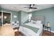 Comfortable bedroom with hardwood floors, upholstered headboard, and decorative shelving at 1617 Jenkins Rd, Wake Forest, NC 27587
