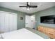 Bedroom featuring hardwood floors, accent wall, large dresser, and a ceiling fan at 1617 Jenkins Rd, Wake Forest, NC 27587