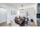 Dining room with modern chandelier, neutral paint, and view of sliding glass door to back yard at 1617 Jenkins Rd, Wake Forest, NC 27587