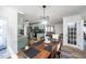 Eat-in kitchen and dining room with light green cabinetry, granite counters and stainless steel appliances at 1617 Jenkins Rd, Wake Forest, NC 27587
