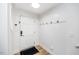 Bright entryway with white paneled walls, coat hooks, and a wood-look floor at 1617 Jenkins Rd, Wake Forest, NC 27587