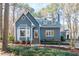 Charming blue home with bay window, wooden shutters and brick walkway surrounded by landscaping at 1617 Jenkins Rd, Wake Forest, NC 27587