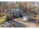 Charming home nestled among trees with a long driveway and matching detached garage at 1617 Jenkins Rd, Wake Forest, NC 27587