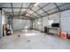 Spacious garage interior with concrete floors, metal walls, and overhead lighting at 1617 Jenkins Rd, Wake Forest, NC 27587