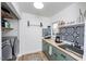 Modern laundry room with gray washer and dryer, butcher block counters and black and white patterned backsplash at 1617 Jenkins Rd, Wake Forest, NC 27587