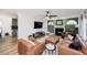Open-concept living room with fireplace, arch-top windows and views into the kitchen at 1617 Jenkins Rd, Wake Forest, NC 27587