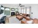 Cozy living room featuring a fireplace, leather furniture, and ample natural light at 1617 Jenkins Rd, Wake Forest, NC 27587