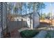 Metal outbuilding with white door and windows beyond fence at 1617 Jenkins Rd, Wake Forest, NC 27587