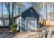 Outbuilding with white garage door, window, and light fixtures at 1617 Jenkins Rd, Wake Forest, NC 27587