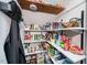Walk-in pantry with tons of built-in shelves and well organized storage at 1617 Jenkins Rd, Wake Forest, NC 27587