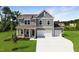Charming two-story home with a two-car garage, a covered porch, and a nicely manicured lawn at 18 Cribbs Ln, Middlesex, NC 27557