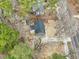 Aerial view of a single-Gathering home on a spacious wooded lot with a long driveway near a main road at 1911 Stadium Dr, Durham, NC 27705