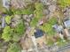 Aerial view of a single-Gathering home on a spacious wooded lot near other homes at 1911 Stadium Dr, Durham, NC 27705