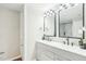 Modern bathroom with double vanity, framed mirrors, and walk-in shower at 1911 Stadium Dr, Durham, NC 27705
