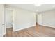 Large bedroom with hardwood floors leads to the bathroom; perfect for a primary suite at 1911 Stadium Dr, Durham, NC 27705