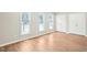 Bright bedroom with hardwood floors, three windows, and plenty of natural light; nice closet space at 1911 Stadium Dr, Durham, NC 27705