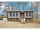 Charming two-story home with gray siding, brick foundation, and a well-manicured lawn at 1911 Stadium Dr, Durham, NC 27705
