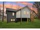 Back exterior view of home showcasing a deck, white siding, and well-maintained backyard at 1911 Stadium Dr, Durham, NC 27705