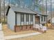 Charming home with gray siding, brick foundation, black window trim and a cozy front porch at 1911 Stadium Dr, Durham, NC 27705