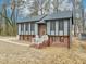 Charming home with gray siding, brick foundation, black window trim, and a cozy front entrance at 1911 Stadium Dr, Durham, NC 27705