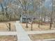 Charming home with gray siding, brick foundation and a long driveway and partially wooded lot at 1911 Stadium Dr, Durham, NC 27705