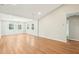 Spacious living room with hardwood floors and freshly painted, neutral walls; adjoining the dining area at 1911 Stadium Dr, Durham, NC 27705