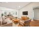 Bright living room featuring hardwood floors, neutral walls, and comfortable seating flowing into the dining area at 1911 Stadium Dr, Durham, NC 27705