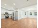 Open-concept kitchen, dining, and living area with stainless steel appliances and hardwood flooring throughout at 1911 Stadium Dr, Durham, NC 27705