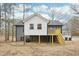 Rear exterior shows a white extension on a gray home with a small deck at 1911 Stadium Dr, Durham, NC 27705