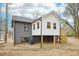 View of the back of the home shows recent construction with elevated extension and stairs at 1911 Stadium Dr, Durham, NC 27705