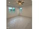 Bright bedroom with ceiling fan, tray ceilings, and two large windows offering natural light at 1912 Harrell Cove Ct # 171 Gunnison Cr, Fuquay Varina, NC 27526