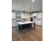 Bright kitchen features a spacious island with marble countertops, stainless steel appliances, and white cabinetry at 1912 Harrell Cove Ct # 171 Gunnison Cr, Fuquay Varina, NC 27526