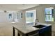 Open concept kitchen with island, stainless steel sink, and view of the living room and deck at 1912 Harrell Cove Ct # 171 Gunnison Cr, Fuquay Varina, NC 27526