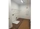 The laundry room has wood floors, bright white walls, utility connections, and a wire shelf at 1912 Harrell Cove Ct # 171 Gunnison Cr, Fuquay Varina, NC 27526