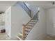 Staircase featuring wood handrails and black wrought iron spindles leading to the second floor at 1912 Harrell Cove Ct # 171 Gunnison Cr, Fuquay Varina, NC 27526