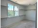 Walk-in closet with natural light, shelves and hanging rods at 1912 Harrell Cove Ct # 171 Gunnison Cr, Fuquay Varina, NC 27526