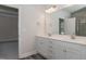 Bathroom featuring a double sink vanity, a large mirror, tile flooring and views of the walk-in shower at 20 Watermelon Dr, Franklinton, NC 27525