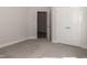 Bedroom with neutral carpeting, a double door closet, and an additional doorway at 20 Watermelon Dr, Franklinton, NC 27525