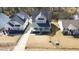 Aerial view showcasing a charming gray house with a welcoming front porch and well-kept lawn at 206 Pine St, Fuquay Varina, NC 27526