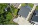 Aerial view showcases the home's roof, the two-car garage and paved driveway at 206 Pine St, Fuquay Varina, NC 27526