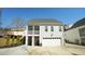 Rear view of house featuring garage, screened in porch and manicured landscaping at 206 Pine St, Fuquay Varina, NC 27526