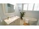 Bright bathroom with a soaking tub, vanity, and shiplap accent wall for spa-like appeal at 206 Pine St, Fuquay Varina, NC 27526