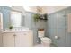 Elegant bathroom features wainscoting, marble countertop, framed mirror, and designer fixtures at 206 Pine St, Fuquay Varina, NC 27526