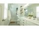 Bright bathroom features double sink vanity, elegant mirrors, floating shelves, and glass shower at 206 Pine St, Fuquay Varina, NC 27526
