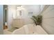 Bright bathroom featuring a soaking tub, shiplap, and a marble countertop at 206 Pine St, Fuquay Varina, NC 27526