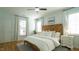 Bright bedroom with wood headboard, ceiling fan, and hardwood floors provides a comfortable and inviting space at 206 Pine St, Fuquay Varina, NC 27526