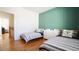 Cozy bedroom featuring two twin beds, green accent wall, and natural light at 206 Pine St, Fuquay Varina, NC 27526